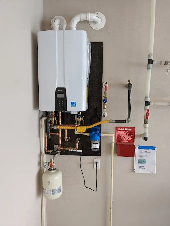 Professional plumber installing copper piping in a Laurel home